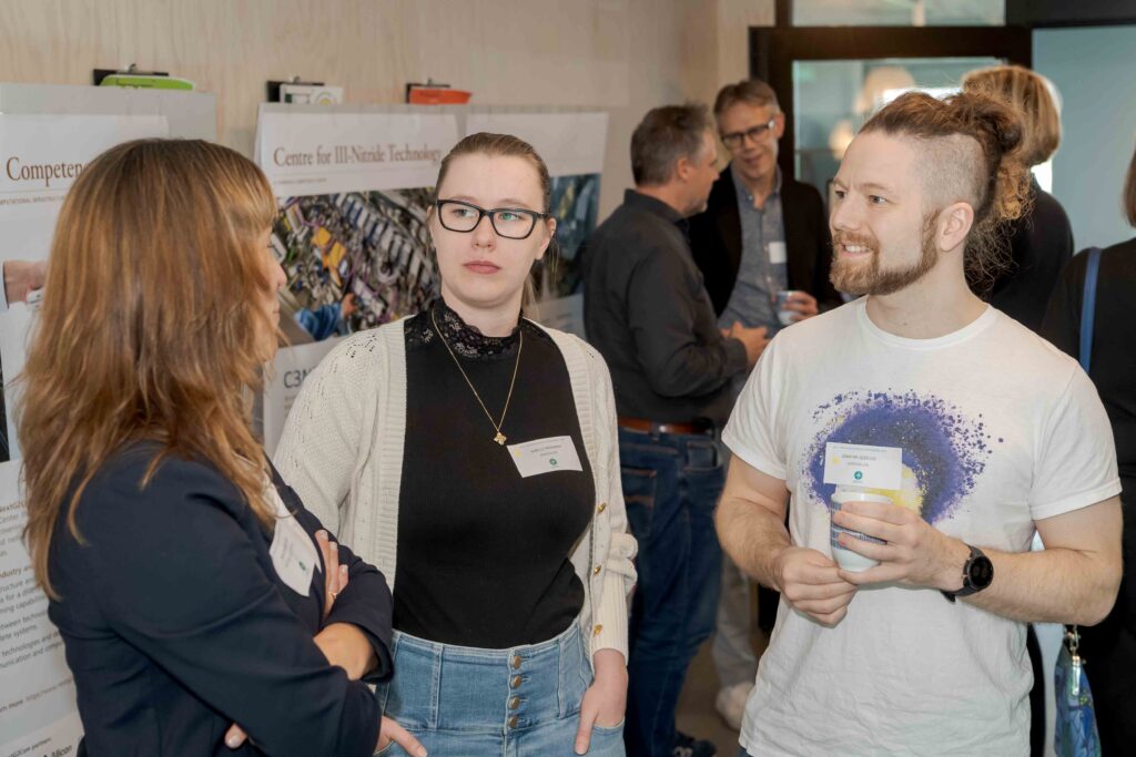 A group of three people at a mingle for startups